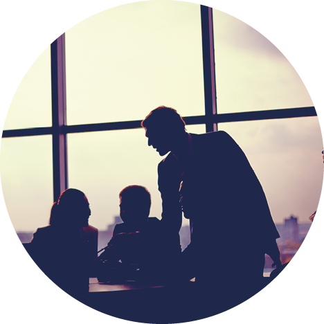 Several colleagues communicating in office against window